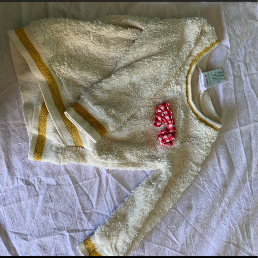 White fluffy sweater. With bow on the chest.